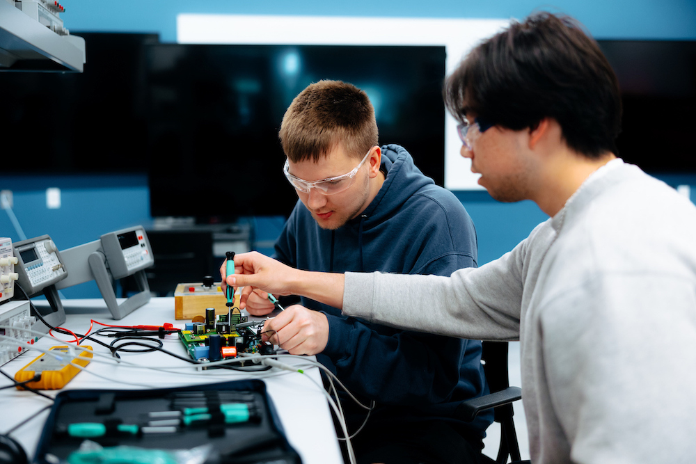 Students working on an electrical circuit board